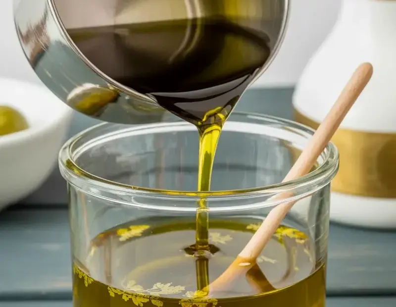 Olive oil pouring with gold leaf – cozy kitchen still life photography